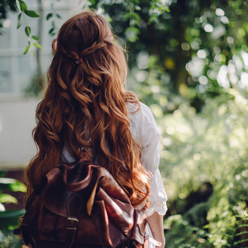 Woman with red hair in nature