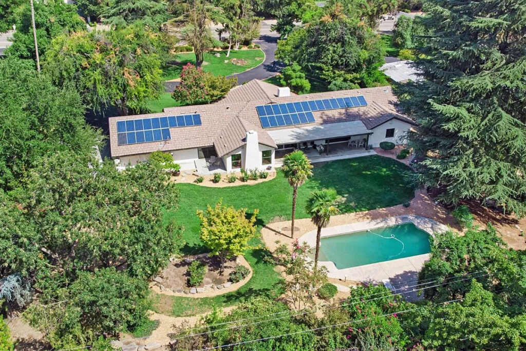 Aerial view of a home with solar panels, harnessing renewable energy for sustainable living.