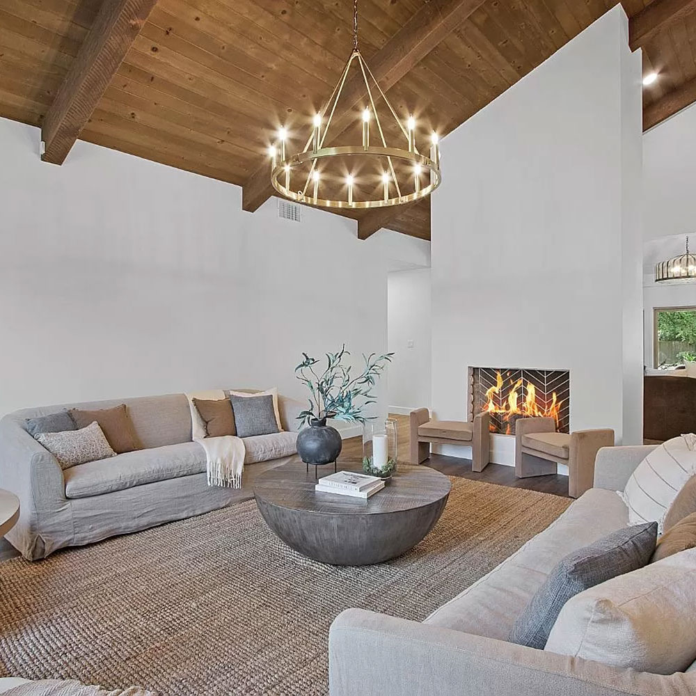 A cozy living room with a fireplace and comfortable couches, perfect for relaxation and warmth.