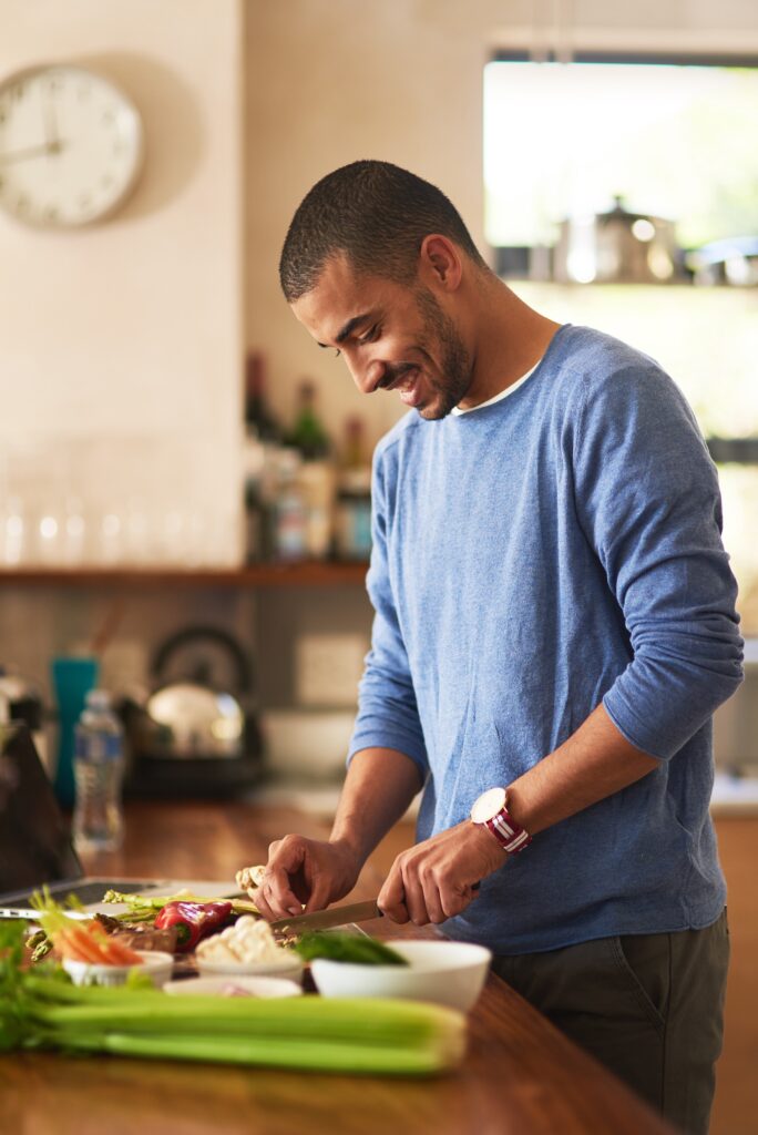 A man making a meal in a sober living home in Fresno